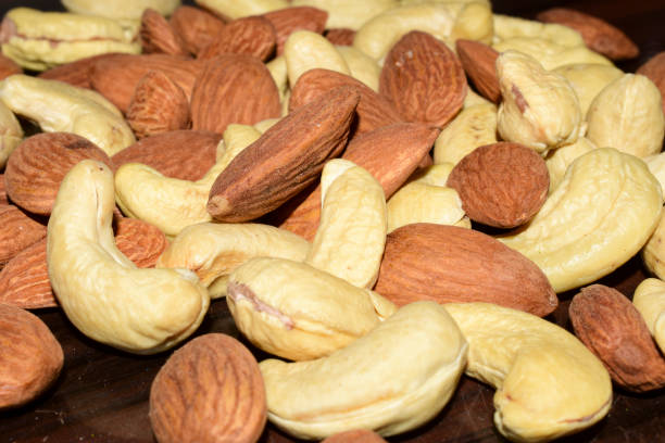 istock Almonds and cashews on wooden on table 1419833369