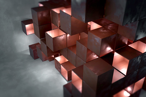 Abstract architecture made of stacked metal cubes with open sides emitting red light. Futuristic engineering and technology. Neutral background with textured effect and copy space.