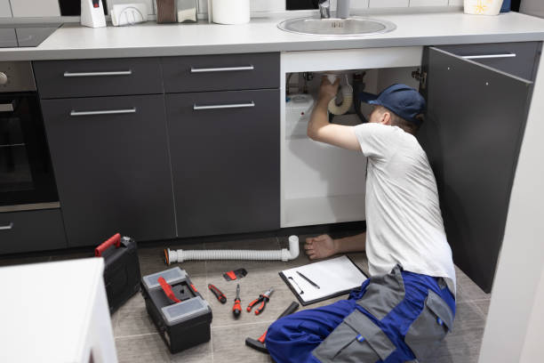 istock Plumber repairing sink in kitchen. 1419835798