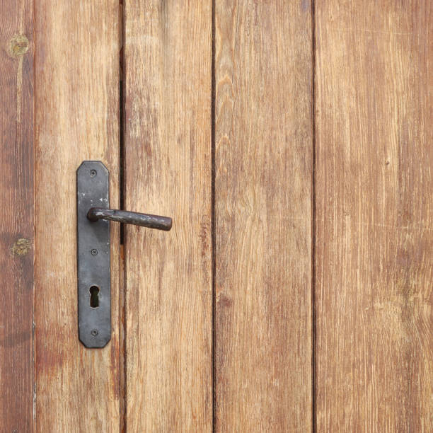 An old wooden door with an iron lock detail stock photo
