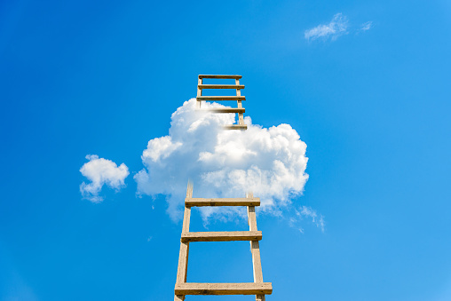 Development, Attainment ,Motivation. Career Growth Concept.Wooden Ladder Leading To A White Cloud blue Sky.Copy space.