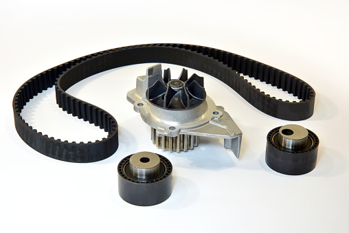 Car engine timing belt, two rollers and water pump. Car engine spare part.