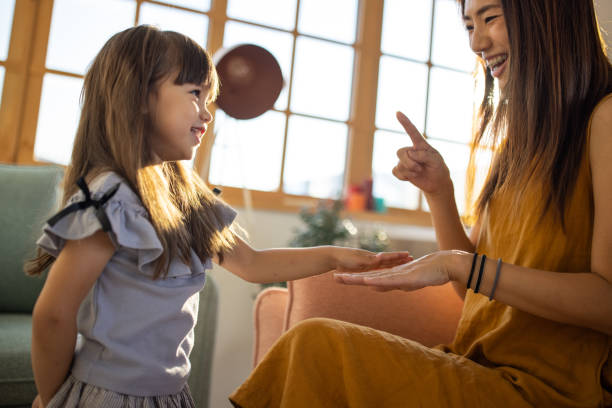 istock Mother and daughter playing hand clapping game 1419846377
