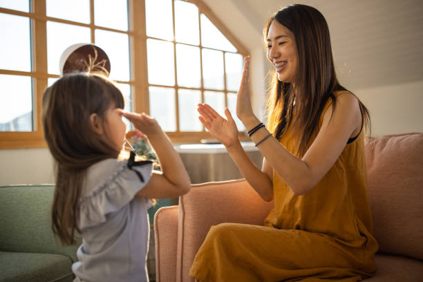 istock Mother and daughter playing hand clapping game 1419846471