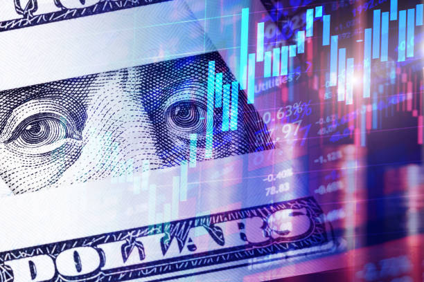 istock Franklin's eyes from a hundred dollar bill with Candlestick charts as a concept of Stock trading or Stock background 1419846718