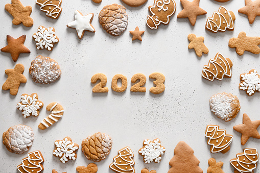 Christmas handmade glazed cookies with date 2023 inside on white background. View from above. Happy New Year.