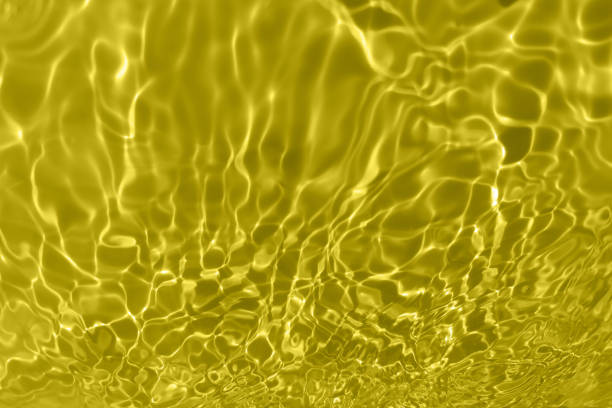 istock Defocus blurred transparent yellow colored clear calm water surface texture with splashes and bubble. Trendy abstract nature background. Water wave in sunlight with copy space. Yellow watercolor shining. 1419848082
