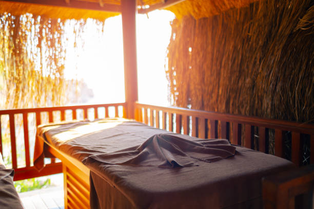 Massage table with sun canopy by the sea in resort hotel