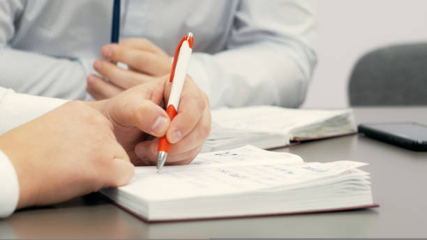 istock Employee in the conference room makes notes in his notebook 1419850287