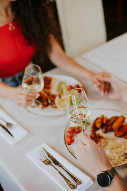 istock Young couple having lunch with white wine in the restaurant 1419854845