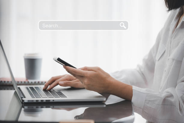 istock closeup woman hands using smart phone with search tab icon 1419855100