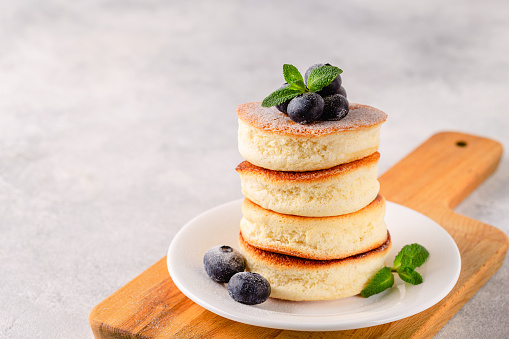 Japanese soft pancakes with berries sprinkled with powdered sugar