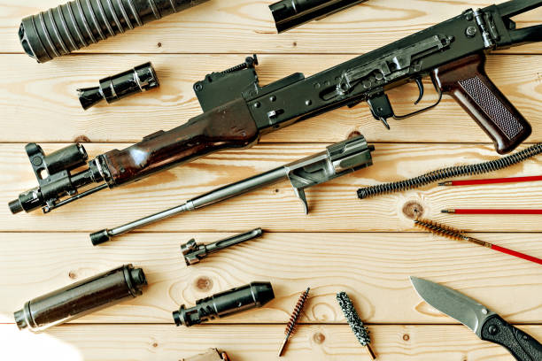 istock Disassembled rifle with cleaning tools on table of weapons workshop 1419859342