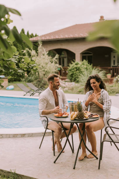 istock Young couple sitting in the backyard 1419859642