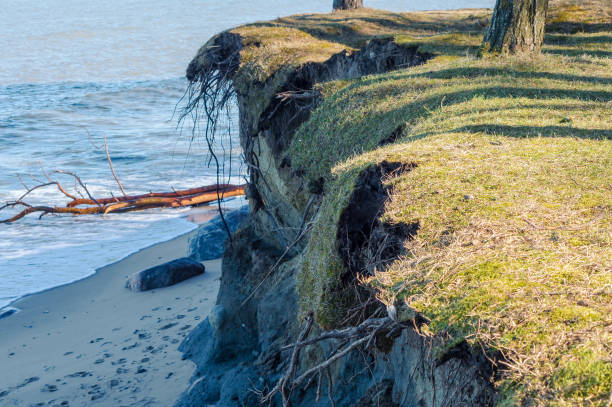 Destruction on a seashore. The erosion of the sea shore. Erosion on the cliffs. Coastal crumbling after a storm. stock photo