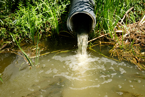 Sewage pipe discharges sewage and wastewater into the river. Environmental pollution
