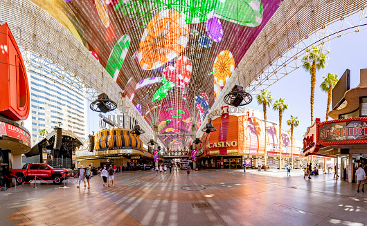 Las Vegas, USA - May 24, 2022: Hustle and bustle of crowds during the day on the famous Fremont Street in the heart of downtown Las Vegas with its Casinos, Neon Lights and Street Entertainment.