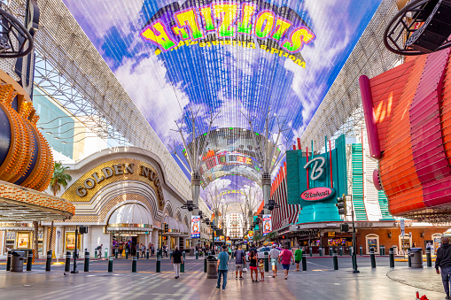 Las Vegas, USA - May 24, 2022: Hustle and bustle of crowds during the day on the famous Fremont Street in the heart of downtown Las Vegas with its Casinos, Neon Lights and Street Entertainment.