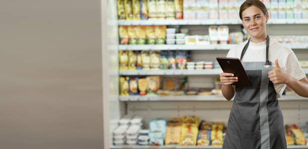 istock supermarket clerk using apps on a digital tablet, innovative technology and work concept, young female supervisor with tablet pc in the mall. Retail concept. banner 1419866424