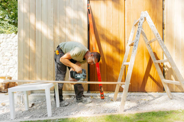 Photo of a man working on a garden house