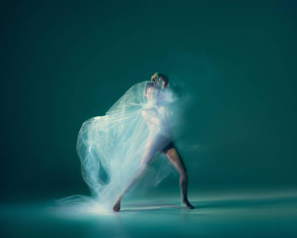 istock Graceful ballet dancer dancing with white cloth, fabric isolated on green background. Art, motion, action, flexibility, inspiration concept. 1419868517