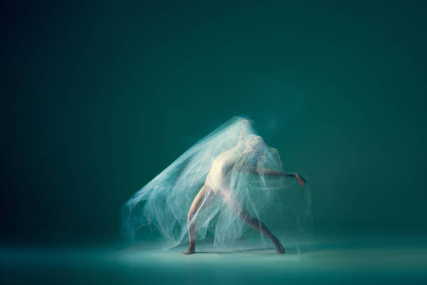 istock Graceful ballet dancer dancing with white cloth, fabric isolated on green background. Art, motion, action, flexibility, inspiration concept. 1419868538