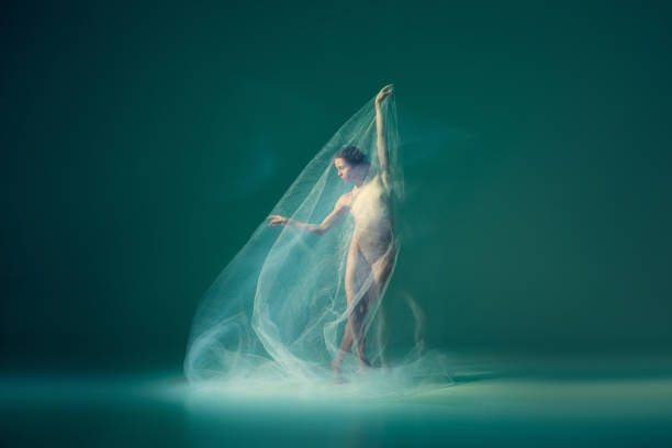 istock Solo. Beautiful and graceful ballet dancer dancing with white transparent cloth, isolated on cyan color background. Art, fantasy, flexibility, inspiration concept. 1419868557
