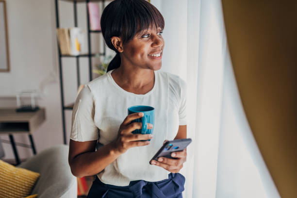 istock Woman using smart phone at home 1419869754