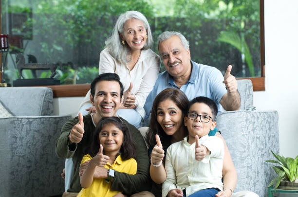 Multi-Generation Family Giving Thumbs Up Gesture Multi-Generation Family Giving Thumbs Up Gesture And Smiling father in law stock pictures, royalty-free photos & images