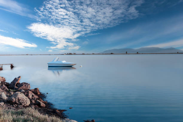 Photo of boat under the blue sky and clouds. Boat moored in the sea