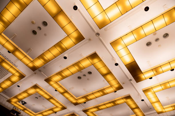 istock conceptual chandeliers, square yellow lamps on white ceiling 1419871405