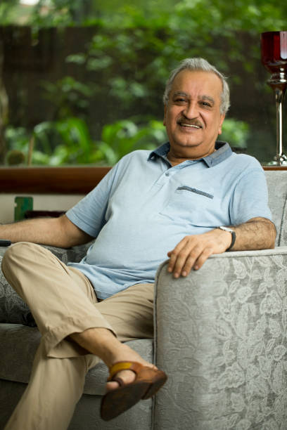 istock Senior Man Sitting On Armchair And Smiling 1419871540