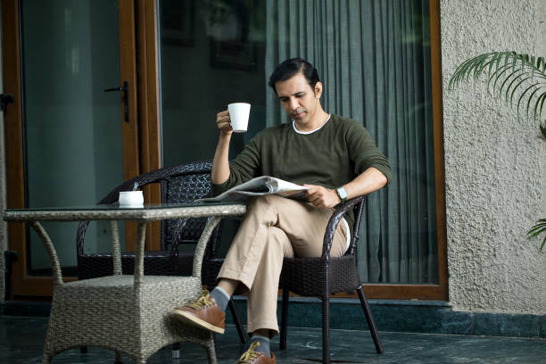 istock Mid Adult Man Reading A Newspaper And Drinking Coffee 1419871755