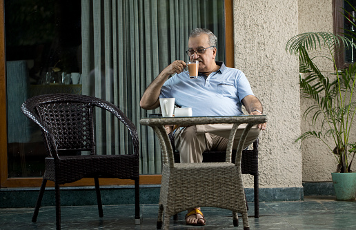Old Man Having Tea While Relaxing At Home
