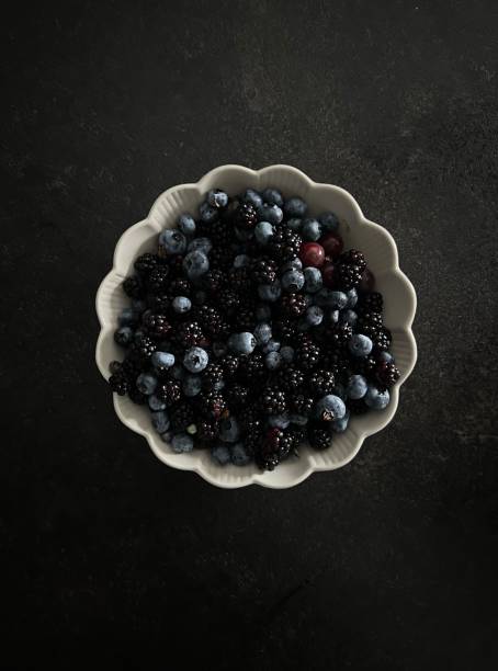 blackberry and blueberry on a black background top view