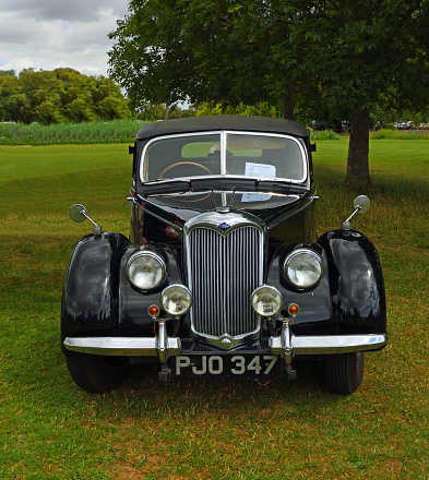 St Neots, Cambridgeshire, England - July 02, 2022: Classic Black  Riley RMA  Motor Car Parked on glass.