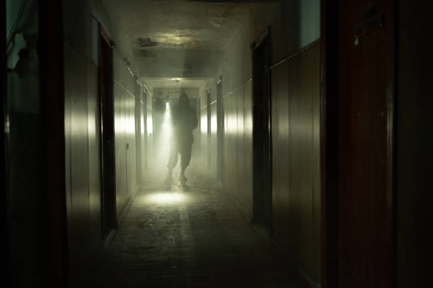 Brave post apocalyptic survivor with gas mask and flashlight walk on building. environmental disaster, crime and chemical warfare concept