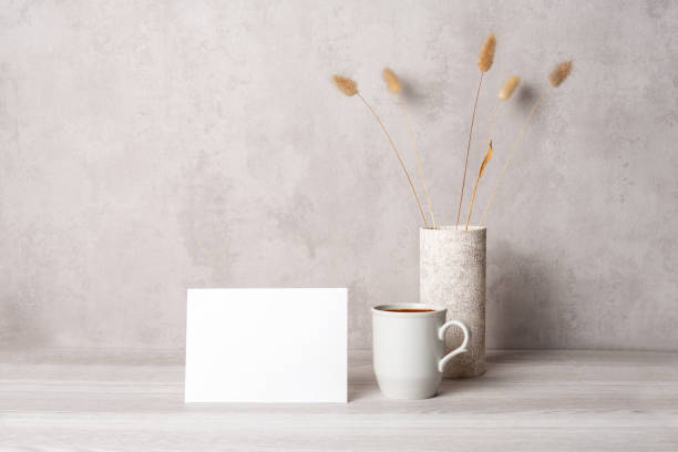 istock Template with photo frame on a wooden table. Bouquet Lagurus. Sunlight from the window. 1419875439