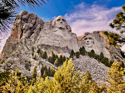 View of U.S. Presidents George Washington, Thomas Jefferson (partial view), Theodore Roosevelt (obscured), and Abraham Lincoln sculptures at Mount Rushmore National Monument.