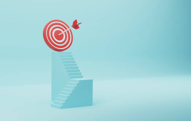 istock Red dartboard sits atop a blue stair on a blue background. 1419882007