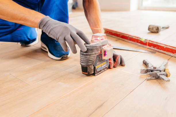 istock Worker in grey protective gloves installation building laser level with red beams 1419883567