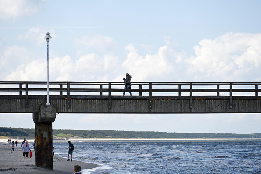 Zinnowitz, Germany, May 12, 2022 - People on the pier on the beach of Zinnowitz on the Baltic Sea in Germany