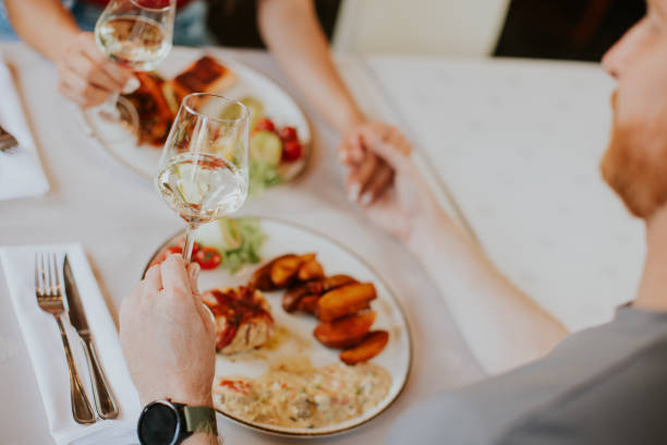 istock Young couple having lunch with white wine in the restaurant 1419887782