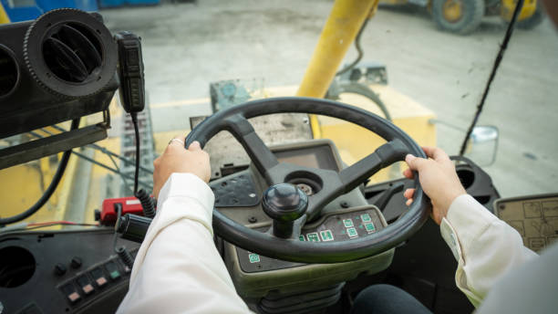 istock Female Foreman Drive a forklift container cargo forklift and use walkie talkie for communication during Driveing control forklift concept service and transportation logistic. 1419890559