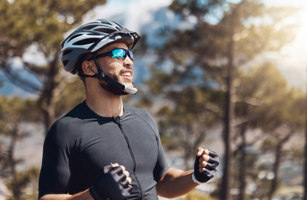 istock Cheerful sportsman celebrating victory or success while training outdoors in nature environment. Healthy and fit male cyclist smiling and celebrating after reaching his goal 1419892094