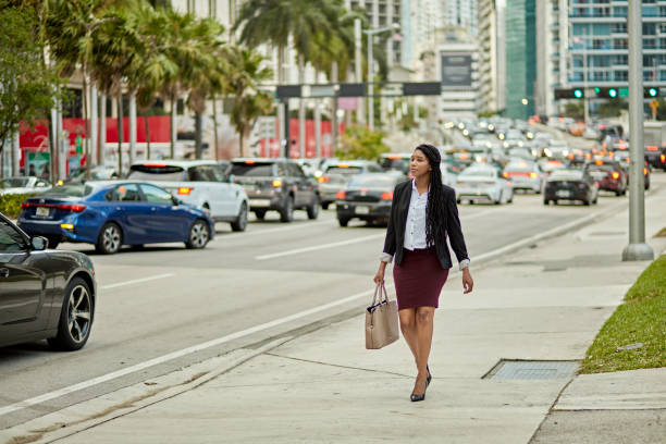 Young Miami businesswoman commuting along Brickell Avenue