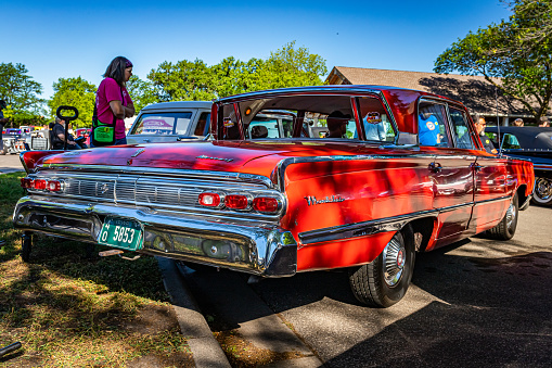 Falcon Heights, MN - June 17, 2022: Low perspective rear corner view of a 1964 Mercury Montclair Breezeway Sedan at a local car show.