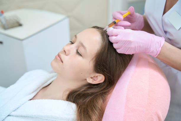istock Cosmetologist makes injection in head client for better hair growth 1419894320