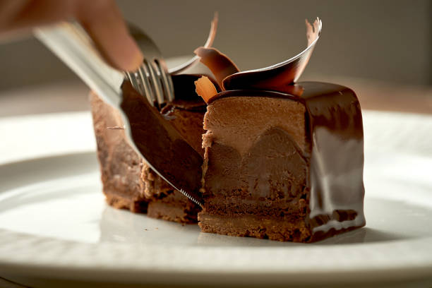 Chocolate mousse cake with frosting. Noise added in post-production. Selective focus stock photo