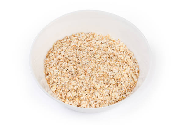 istock Uncooked rolled oats in bowl on a white background 1419897519